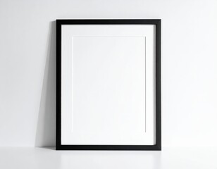 A simple, black framed picture display against a white wall, showcasing a blank, white interior.