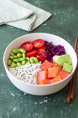 Poke bowl with rice, salmon, avocado, red cabbage, edamame and tomatoes. Healthy food. Diet.