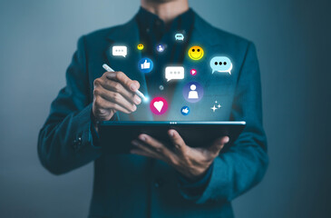Businessman using digital tablet with social media icons, likes, chat, and engagement symbols. Concept of online communication, networking, marketing, and digital interaction.