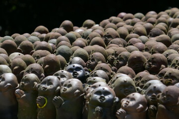 Group of tiny praying statues at Miyajima