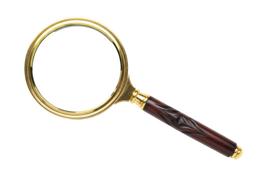 Isolated magnifying glass with gold frame and brown carved wooden handle on display