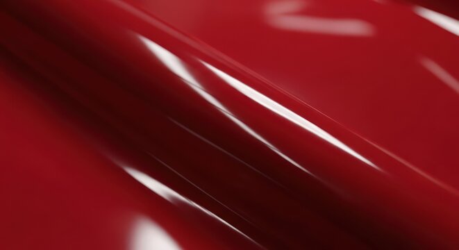 Abstract close up of a glossy textured surface with red tones.