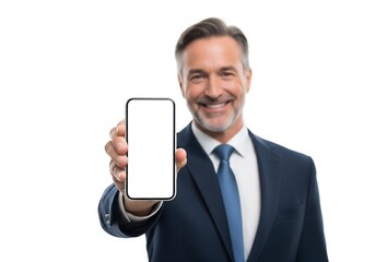 Smiling mature businessman in suit holding smartphone with blank white screen, professional man showing mobile device isolated on white background, technology and communication concept.