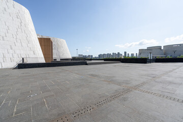 Modern building space with stone walls and paved ground