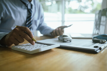 A business agent finalizes a car agreement, with documents, keys, and signature symbolizing insurance, finance, legal contract, and vehicle ownership.