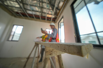 Fototapeta premium Construction workers collaborating on a project in a newly built interior space