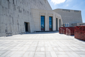 Modern building space with stone walls and paved ground
