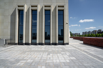 empty brick floor with modern building
