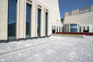 Modern building space with stone walls and paved ground