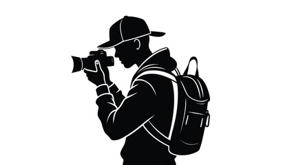 Silhouette of a photographer with a backpack taking a picture