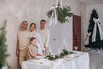 A family of father, mother, son and daughter, together at home at Christmas, beautiful and happy