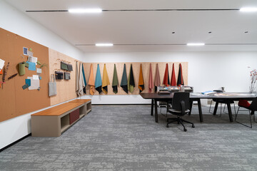 Office space with colorful fabrics, table and chairs