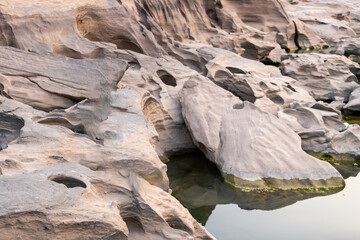 The erosion-marked rocks along the river are a tourist attraction in Thailand called Sam Phan Bok in Ubon Ratchathani Province.