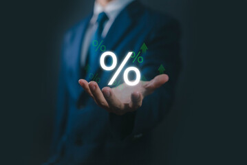 Businessman holding glowing percentage symbol with upward arrows. Concept for interest rates, financial growth, investment return, business profit, banking, economy, and percentage increase.