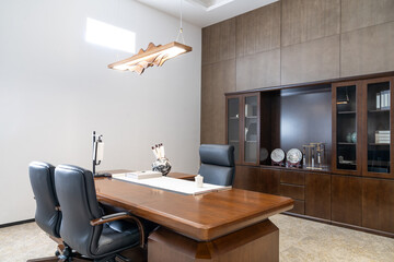 Formal office with wooden desk, chairs and cabinetry