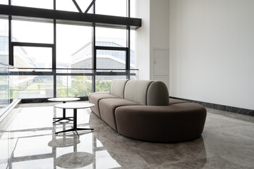 Modern lounge with  sofa and large windows