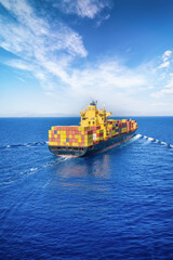 Rear view of a loaded container ship sailing over the ocean for industry, shipping and cargo