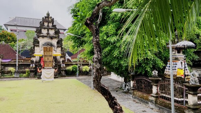 A Bali Hindu temple set in a tropical garden with reflections on sunny water highlighting sacred architecture cultural heritage Hinduism and the island as a popular holiday destination for travelers.