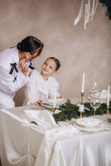 A family of mother and daughter gathered together at home for Christmas, beautiful and happy