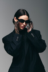 Fashion forward young woman showcases bold style while striking a confident pose