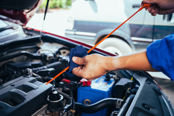 technician changing engine oil and performing vehicle service in a garage, professional auto mechanic work, tools and car parts, clean and organized workshop