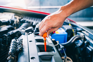 technician changing engine oil and performing vehicle service in a garage, professional auto mechanic work, tools and car parts, clean and organized workshop