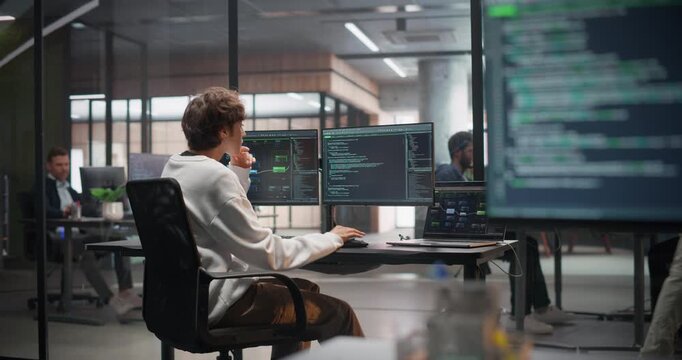 Close Up of a Desktop Computer Monitor with Lines of Code on a Screen. Focus Switch to Female Game Designer or Developer Working in Office. Software Engineer Working on Innovative AI Tools