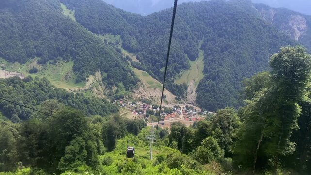 Aerial view from the cable car in Gabala to the peaks of the mountains and green slopes of the Caucasus, Azerbaijan. Tufandag ski resort in summer.