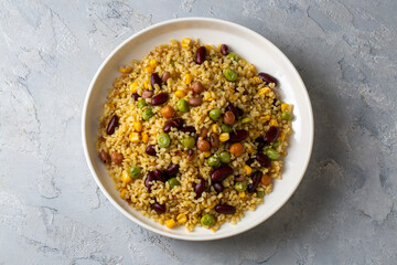 Bulgur pilaf with legumes; with peas, beans and corn kernels.