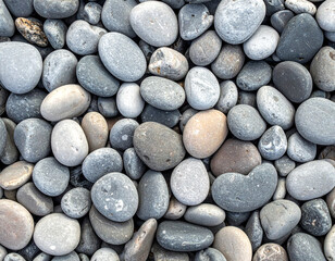 Gray pebbles stones beach texture closeup