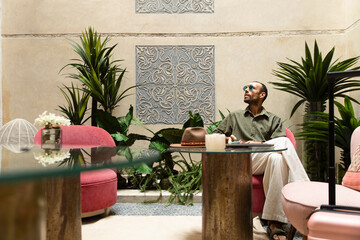 Solo traveler waiting with luggage in modern airport lounge