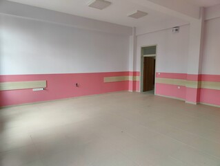 Empty room with pink and white walls—symbolizing potential, simplicity, and the quiet before transformation in a space awaiting purpose or creativity.