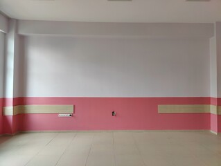 Empty room with pink and white walls—symbolizing potential, simplicity, and the quiet before...