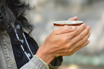 hands with cup of tea