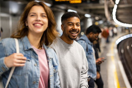 Smiling commuters waiting on London underground platform