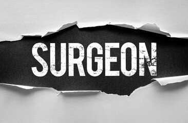 The word "SURGEON" appears in bold distressed lettering beneath a torn paper opening. A conceptual image reflecting medical practice, precision, and the surgical profession