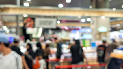 blurred background of cashier activity at checkout counter in supermarket or hypermarket. Ambiance at at the cashier with a crowd of people queuing.
