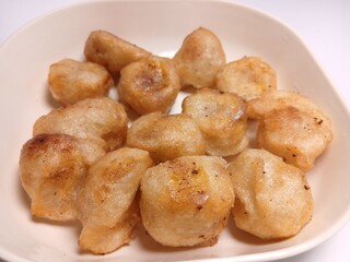 fried bananas or pisang goreng in white bowl. traditional indonesian snack. Isolated on white background