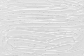 Glossy gel texture with bubbles. Smeared transparent cosmetic gel.
