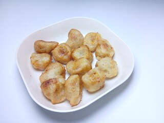 fried bananas or pisang goreng in white bowl. traditional indonesian snack. Isolated on white background