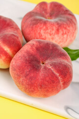 Fresh Red Shaanxi Flat Bottom Peaches on White Cutting Board - Organic Stone Fruit