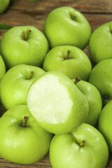Fresh Green Apples from Shaanxi Province China - One Cut Apple Showing White Flesh on Wood Background