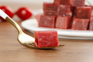 Diced Raw Beef Cubes on Wooden Spoon - Fresh Cut Australian Imported Meat
