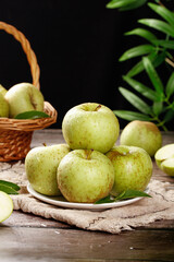 Fresh Green Apples from Shandong China on Rustic Wooden Table with Wicker Basket