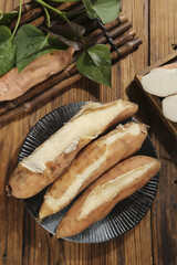 Sweet Potato Slices on Bamboo Mat with Fresh Leaves - Natural Organic Root Vegetable Food Photography