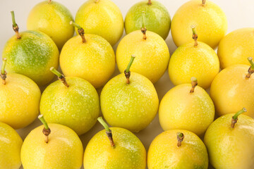 Fresh Golden Passion Fruit with Sparkling Water Droplets on White Background