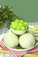 Fresh Green Melon Balls in Hollowed Melon Bowl on Checkered Napkin - Healthy Summer Fruit Presentation