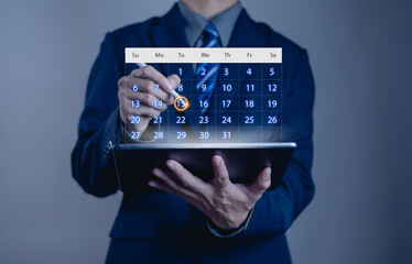 Businessman using digital calendar on tablet for schedule planning, meeting reminder, and event management with modern technology for time management and productivity.