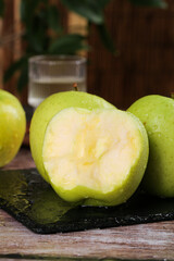Fresh Green Xinjiang Apples on Wooden Surface - Healthy Organic Fruit