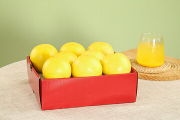 Golden South African Grapefruits in Red Box with Fresh Juice Glass - Healthy Citrus Breakfast